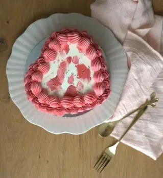 Pink heart-shaped vintage cake on plate