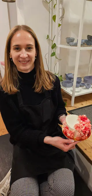 Participant holding a pink cake